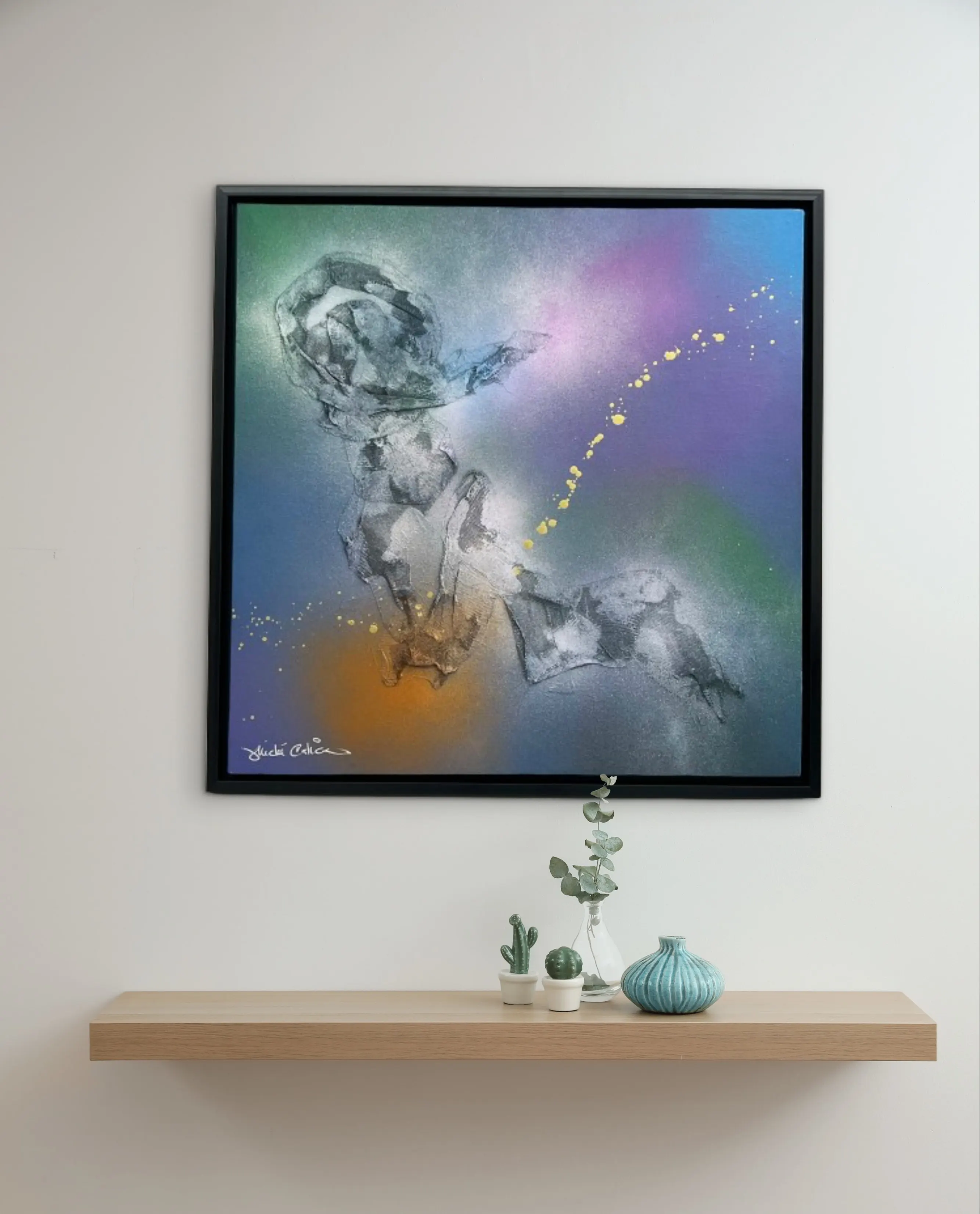 Artwork placed at a comfortable seated sightline beside a dining table